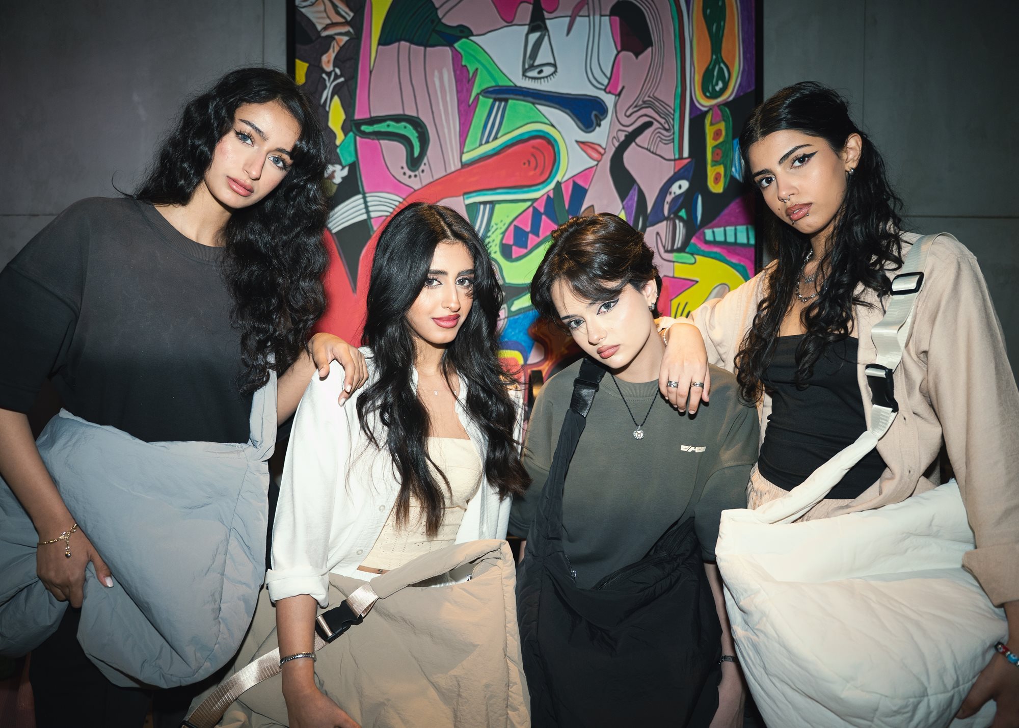 Chow, group of four against vibrant artwork