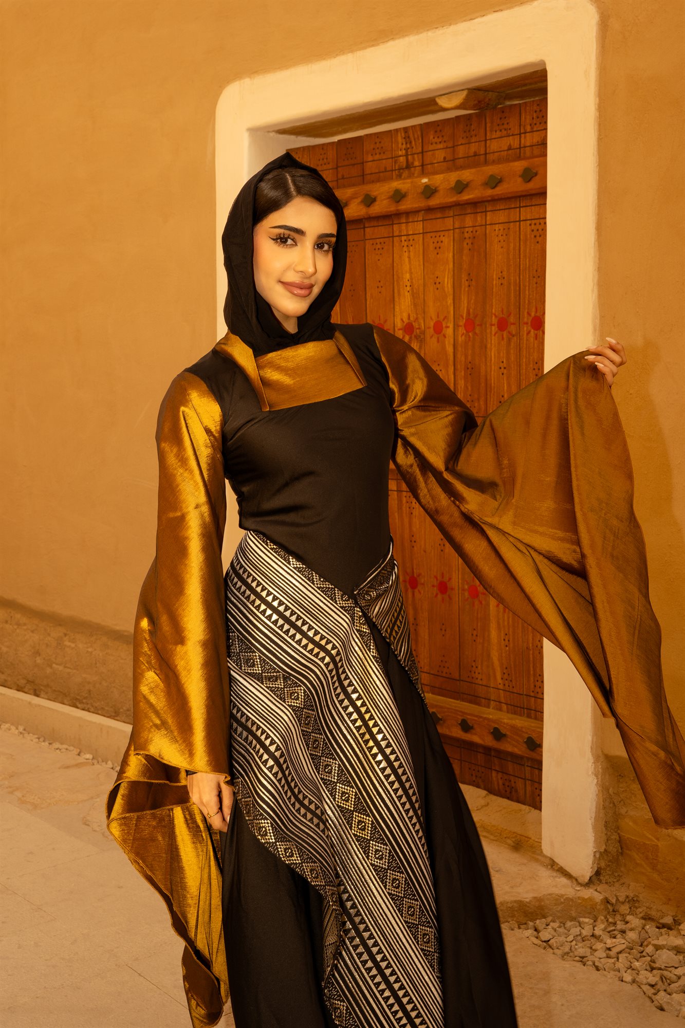 Majd & Thahab, archway portrait in gold and black
