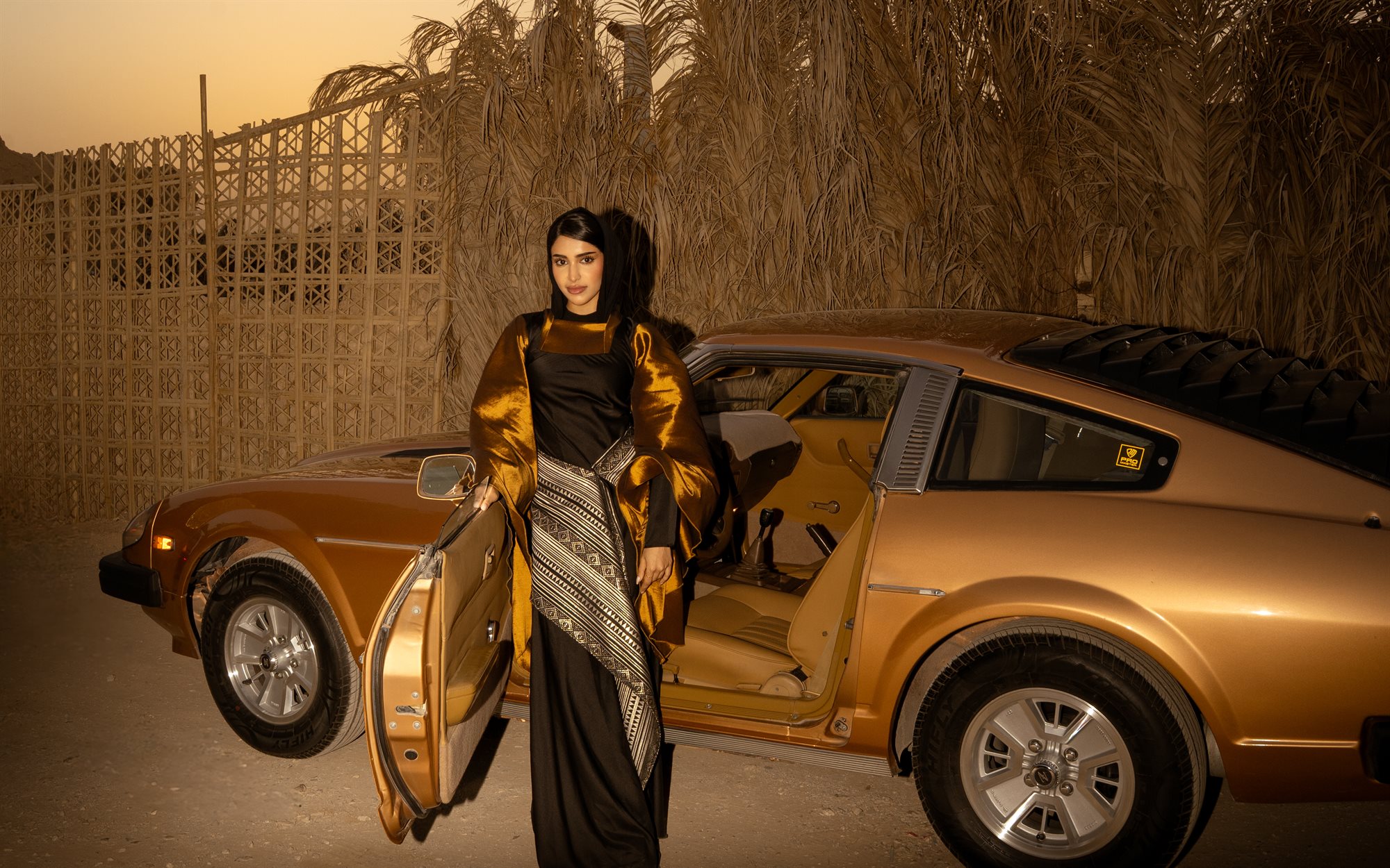 Majd & Thahab, walking by the car at dusk