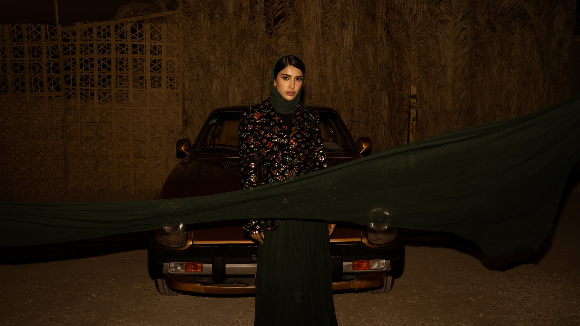 Majd & Thahab, green chiffon trailing in front of the car