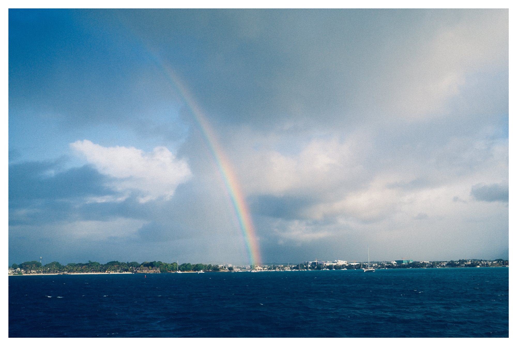Mauritius, a rainbow arcing over the open sea